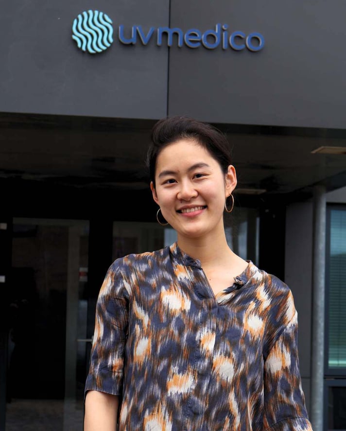 Yiwen, content marketing for UV Medico. Standing in front of the office (Denmark)