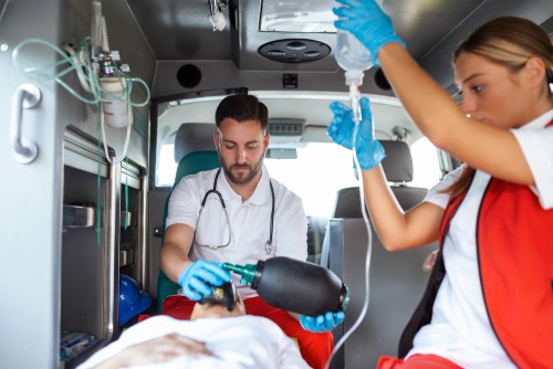 Paramedics treating a patient in an ambulance